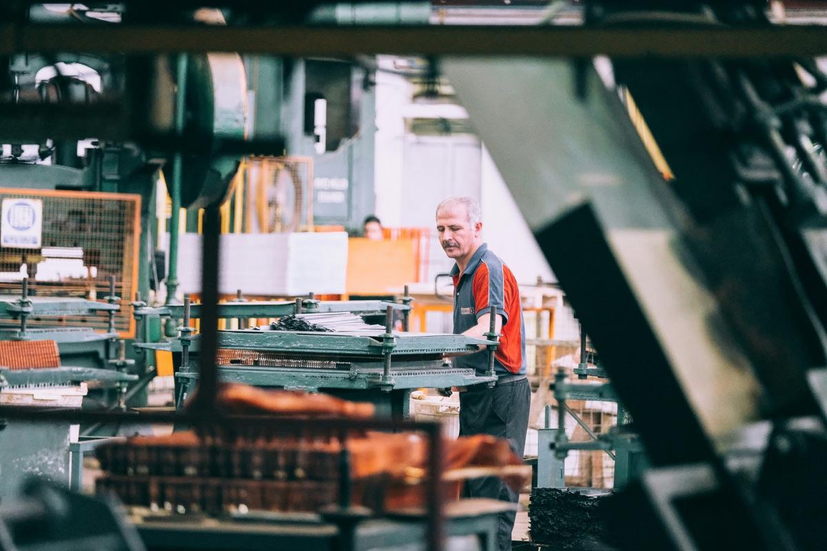 Worker operating industrial manufacturing machinery